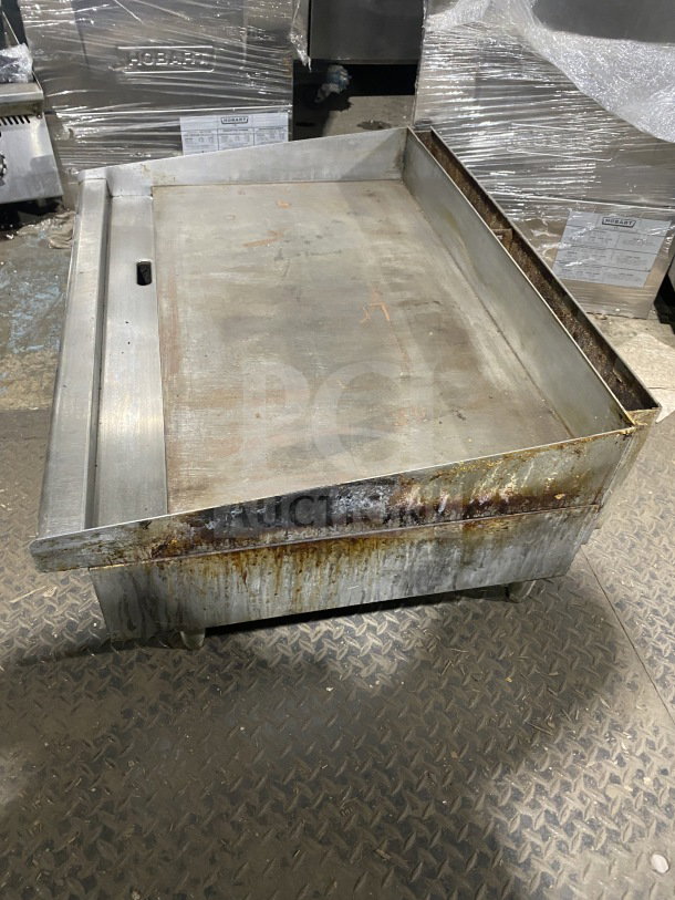 Star Max commercial stainless steel gas griddle with back and side splash, on legs. Moderate wear visible.