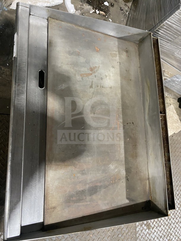 Star Max commercial stainless steel gas griddle with back and side splash, visible wear, mounted on legs.