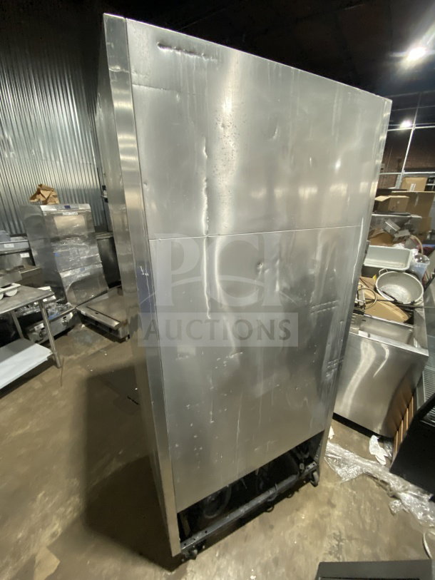 True T-35 stainless steel 2-door reach-in refrigerator on casters, electric powered, with poly coated wired rack.