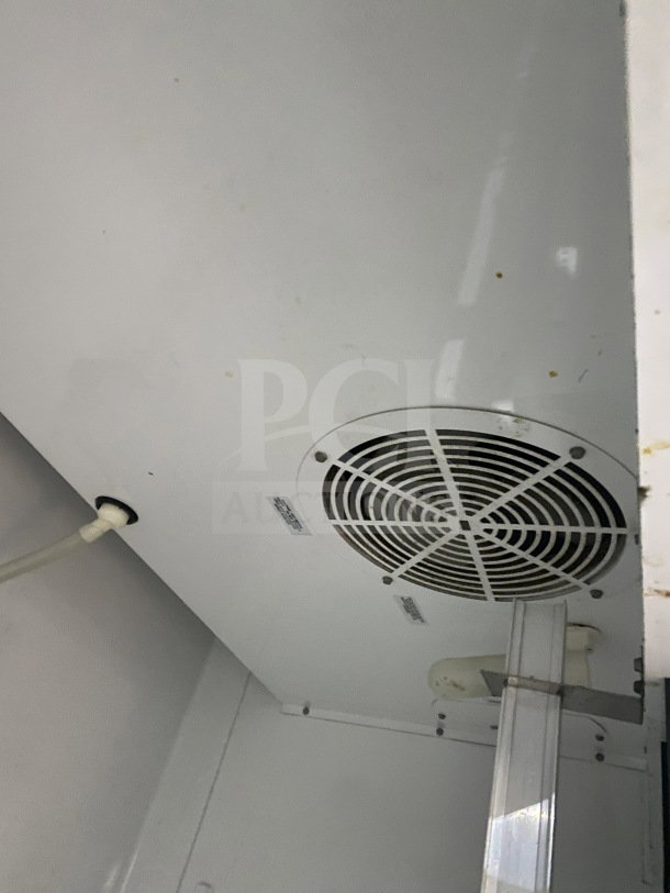 Interior view of True T-35 commercial refrigerator, showing fan vent and wiring. Poly coated rack not visible.