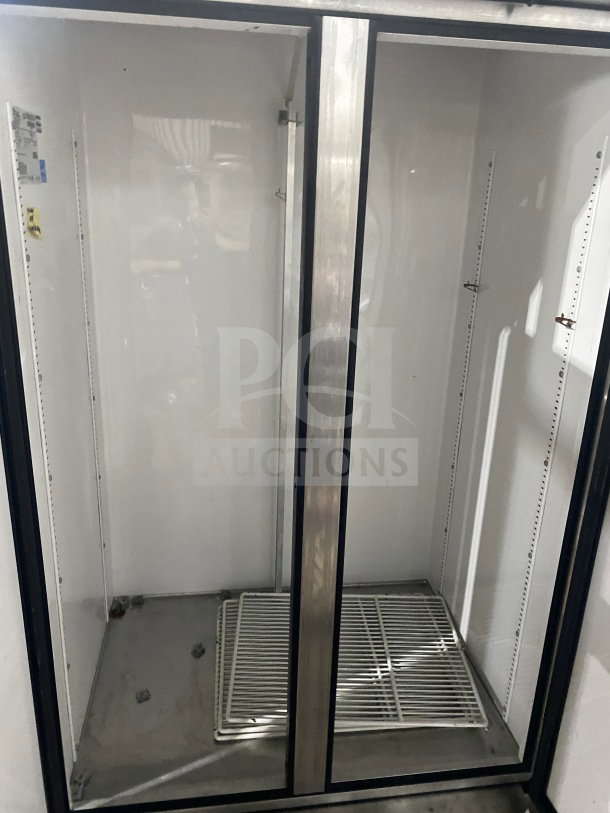 True T-35 commercial stainless steel 2-door reach-in refrigerator with poly-coated wired rack, 115V, on casters.