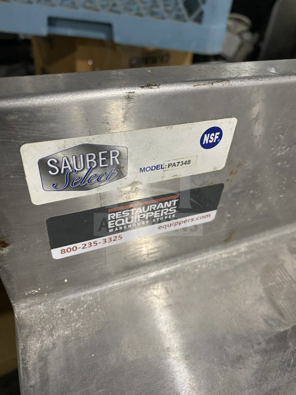 Sauber Select stainless steel worktop table, model PA7348, with backsplash, labels visible, NSF certified.