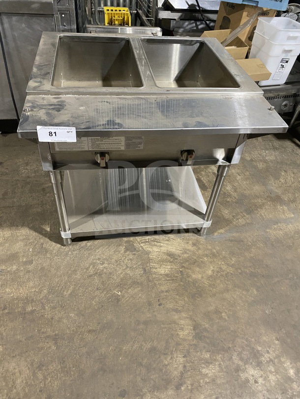 Prepline stainless steel two-well gas steam table with sneeze guard and undershelf, in used condition, on legs.