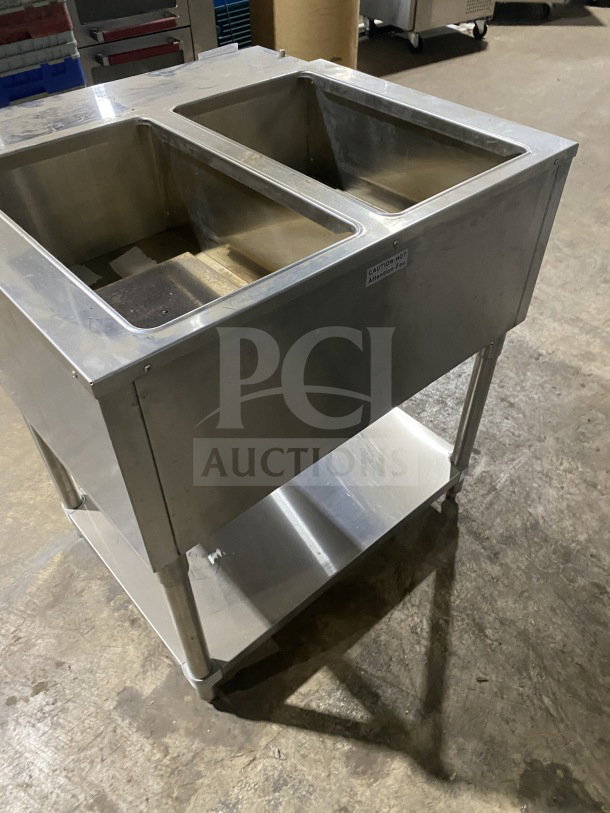 Prepline commercial stainless steel two-well gas steam table with sneeze guard, undershelf, and leg stands, in used condition.
