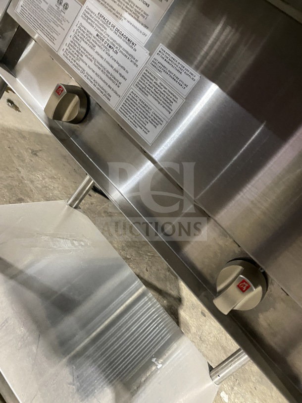 Prepline commercial stainless steel two-well gas steam table with sneeze guard and undershelf, features control knobs.