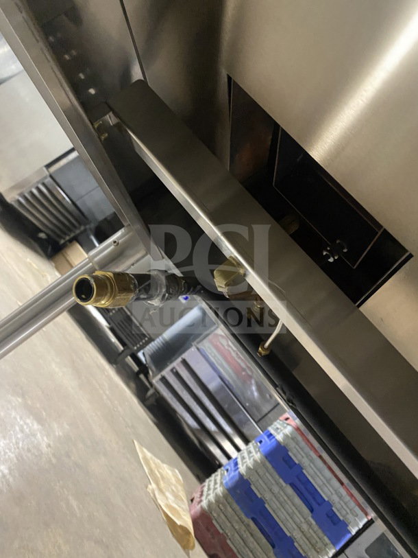 Prepline commercial stainless steel two-well gas steam table with sneeze guard, undershelf, on legs. Gas connection visible.