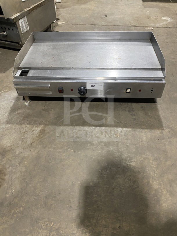 Commercial stainless steel electric countertop griddle with side and back splash, on legs. Model 82, good condition.