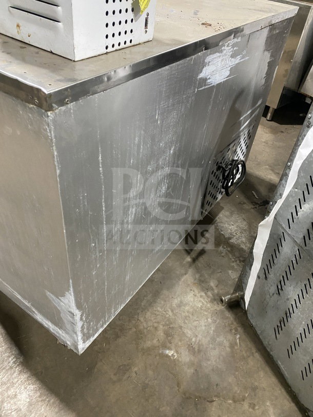 Leader LB48SC stainless steel 2-door lowboy refrigerator on casters. Includes chrome wire rack. Some surface wear visible.