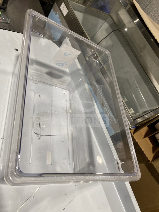 Clear plastic full-size commercial food pan, made of durable polypropylene, in good condition with visible label markings.
