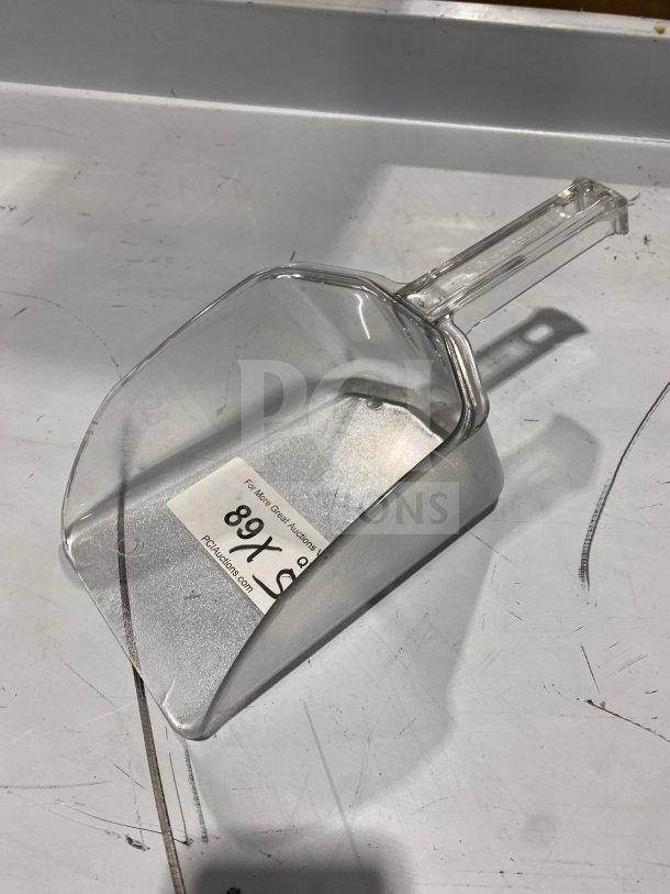 New Camwear commercial clear polycarbonate food scoop, model 9964, in pristine condition. Auction lot tag visible.