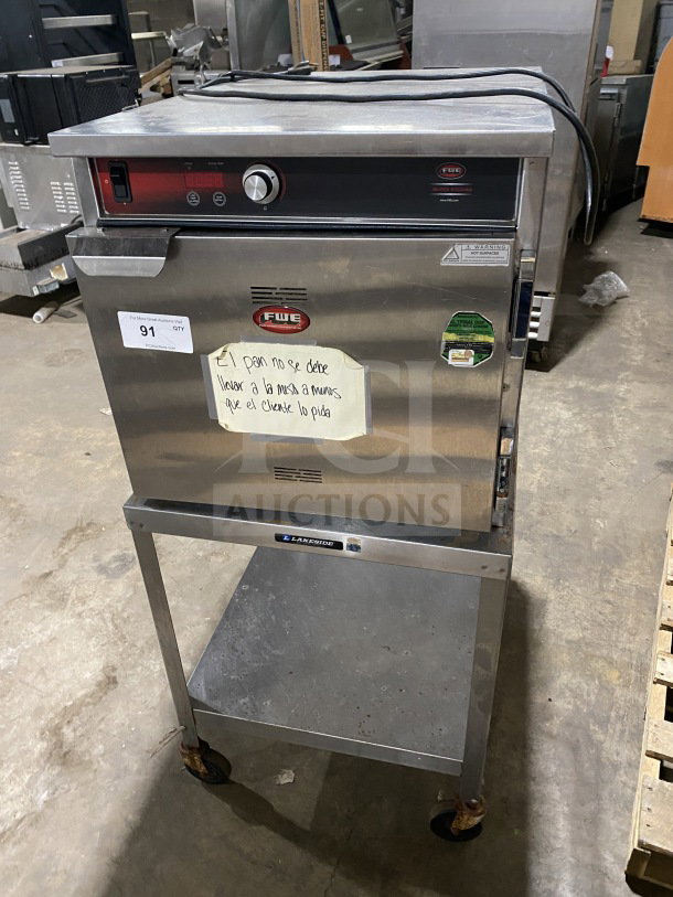 FWE Handy Line Series stainless steel 4-pan heated cabinet, model HLC18264, electric, on casters, with equipment stand.