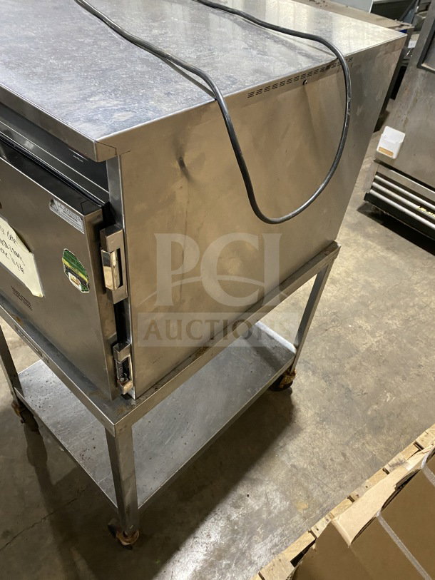 FWE Handy Line stainless steel 4-pan warming cabinet on equipment stand, model HLC18264, 120V, on casters.