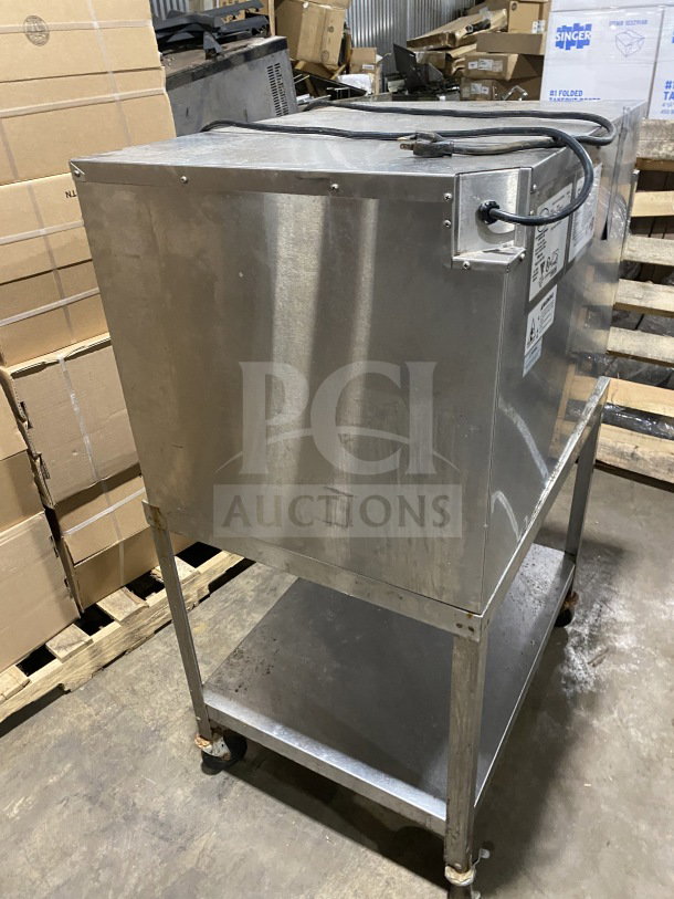FWE Handy Line Series stainless steel warming cabinet, Model HLC18264, on caster-equipped single shelf stand, 120V.