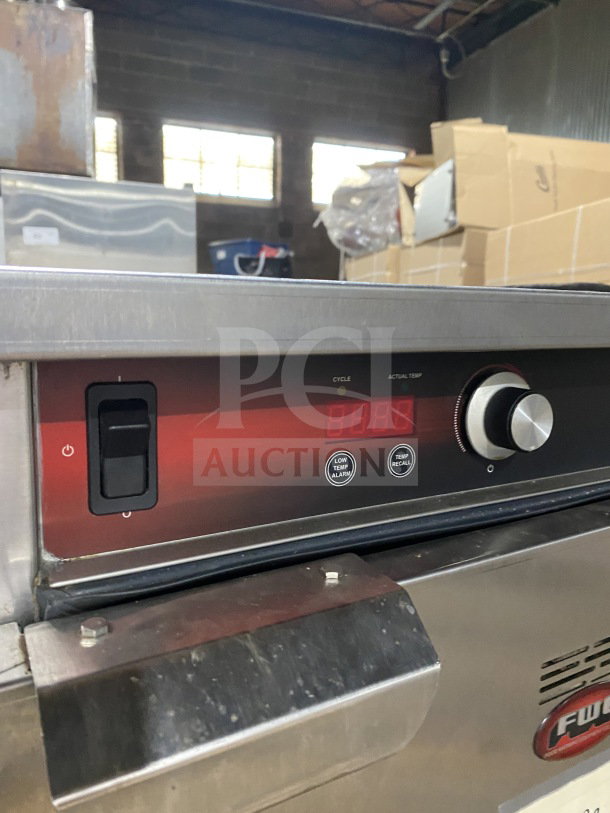 FWE Handy Line Series stainless steel heated cabinet, model HLC18264, on casters. Features digital controls, fits 4 pans.