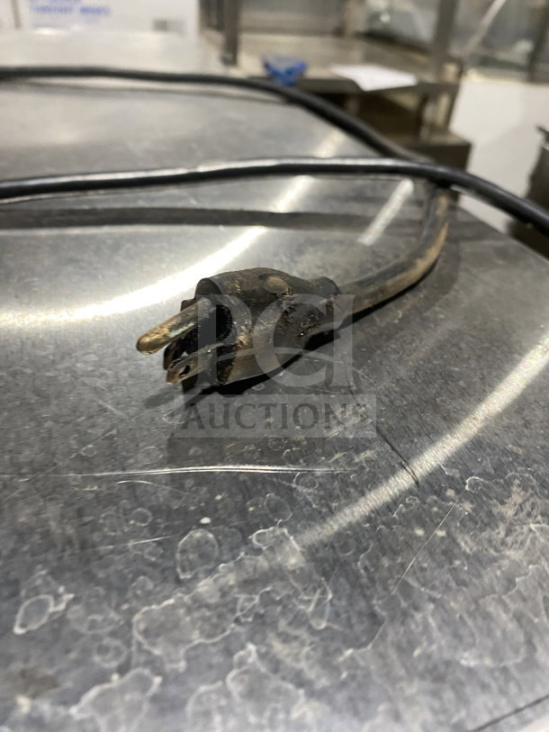 FWE Handy Line Series electric warming cabinet plug and cord, close-up. Surface shows signs of wear. Model HLC18264.