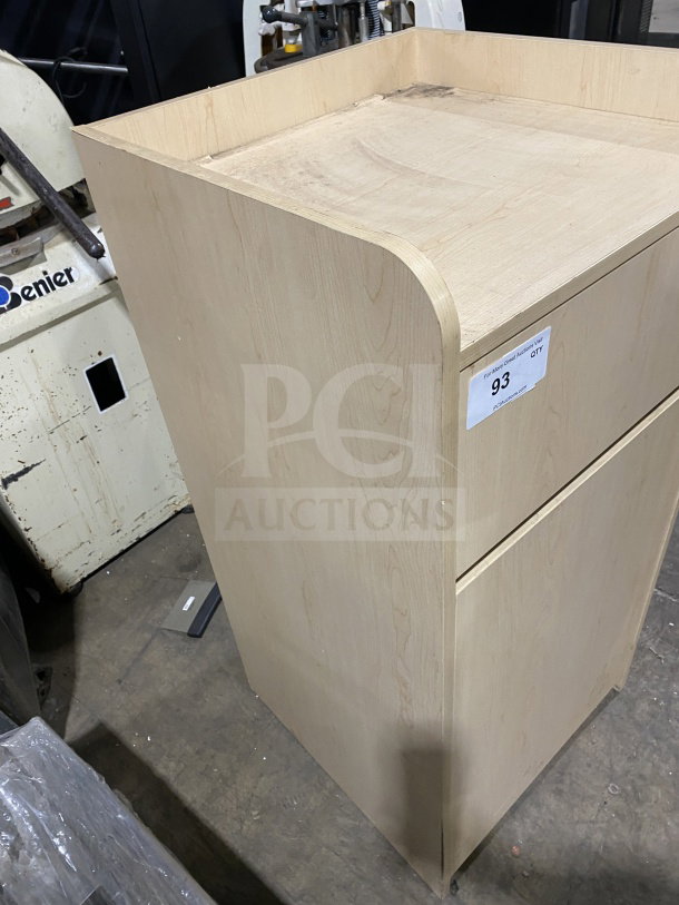Commercial wooden waste enclosure and tray holder station, natural finish, slightly worn condition, auction tag visible.