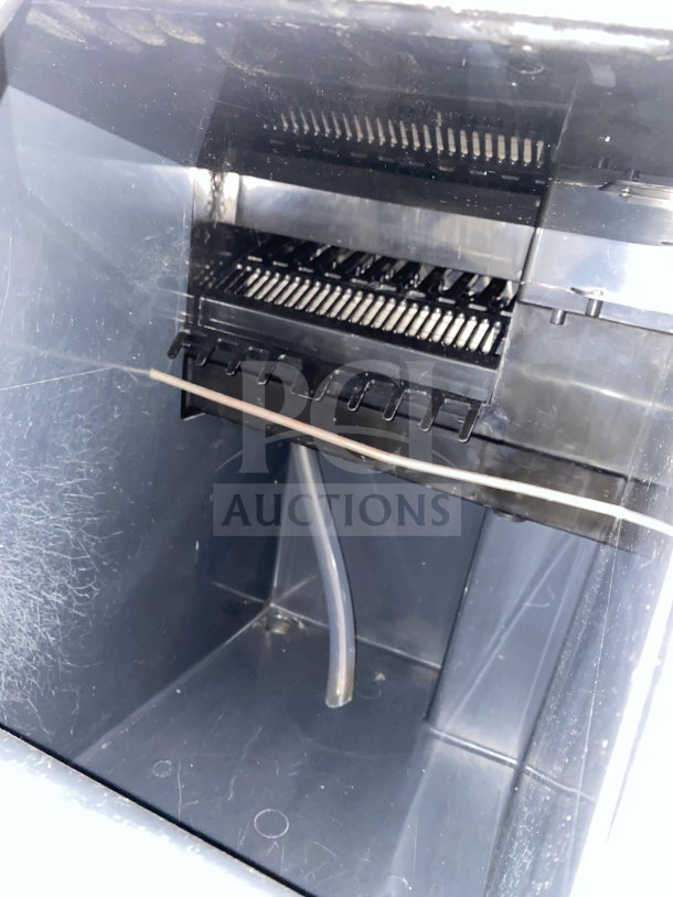 Scotsman undercounter cube ice maker interior view, featuring built-in storage bin and commercial-grade construction.