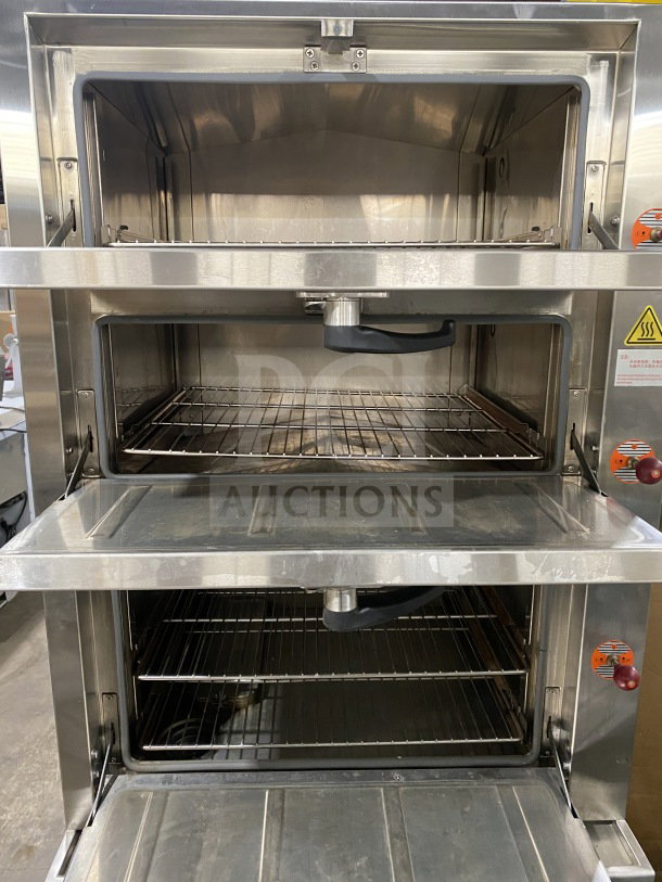FlameMate ESC-3N-N commercial stainless steel 3-compartment steam cabinet, natural gas powered, on legs, open doors.