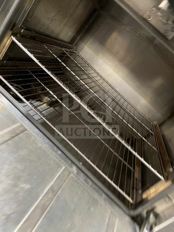 FlameMate ESC3NN stainless steel 3-compartment steam cabinet interior, natural gas powered, on legs, commercial use.
