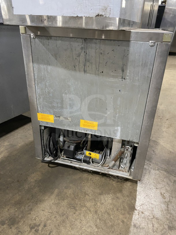 Fagor FUR-27 stainless steel undercounter refrigerator, single door, with poly-coated wire rack, 115V, on casters. Visible wear.