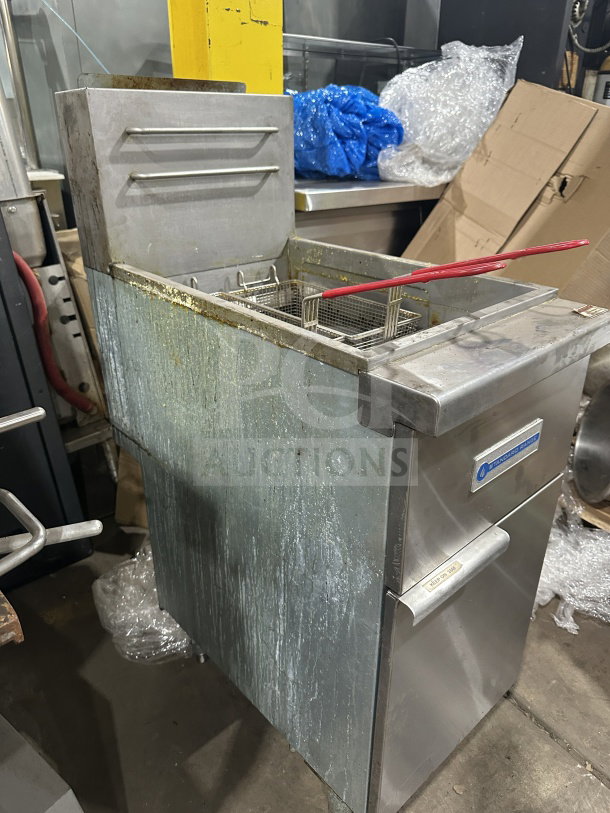 Standard Range SRF4LR gas-powered deep fryer with backsplash and basket. Stainless steel, floor model on legs. Used condition.