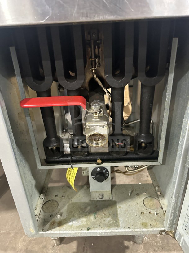 Standard Range SRF4LR stainless steel gas floor deep fryer, with backsplash, fryer basket, and legs, in used condition.