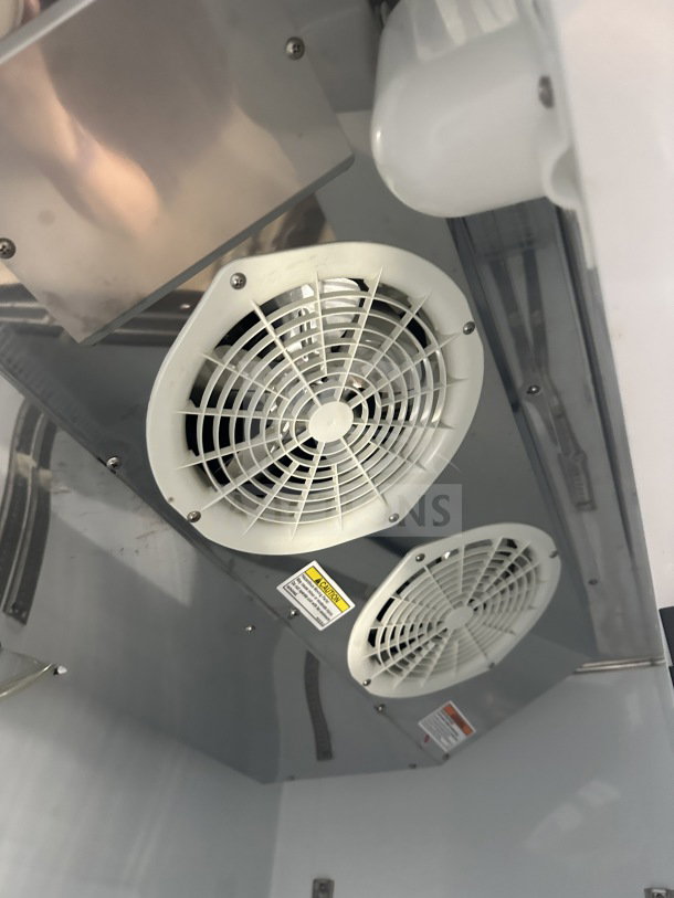 Beverage-Air KF48-1AS interior fans and wiring, showing poly coated rack and caution labels. Clean stainless steel finish.