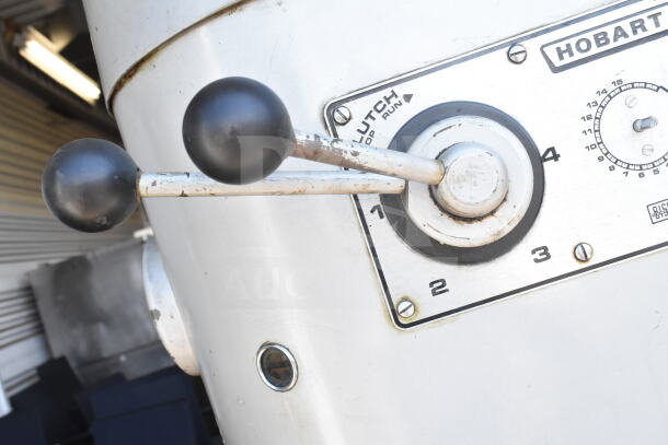 Hobart M802 mixer controls with levers and settings visible; features clutch switch for operation modes.