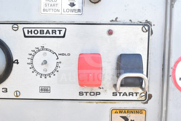 Hobart M802 mixer control panel with start/stop buttons, speed dial, and instructional labels visible.