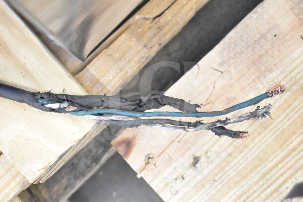 Damaged electrical cable near wood, unrelated to the Avantco 178SSPPT3 Commercial Pizza Prep Table description.
