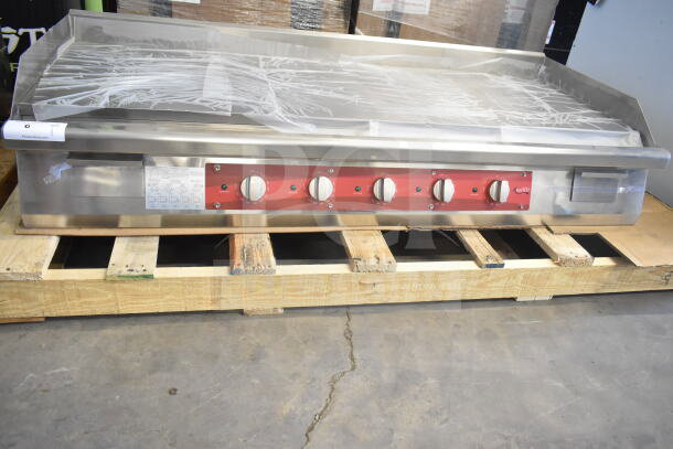Brand new Avantco 177EG60C 60" electric countertop griddle on a pallet. Features red control panel, 208V, 3 phase.
