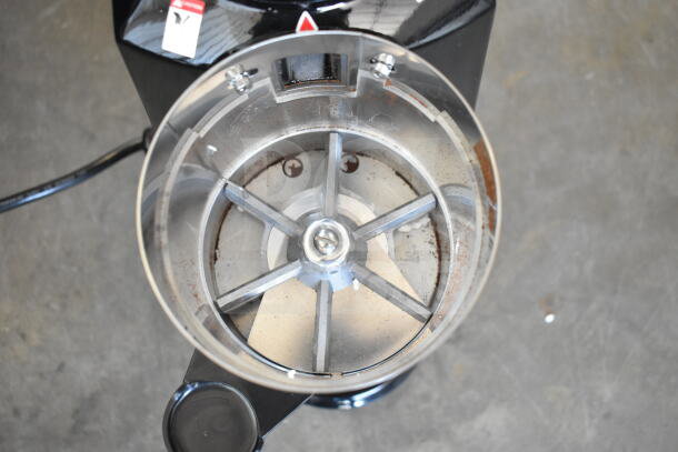 Brand new Estella 236ECEG26 espresso grinder, 120V, 1 phase, visible grind chamber, labeled with caution sticker.