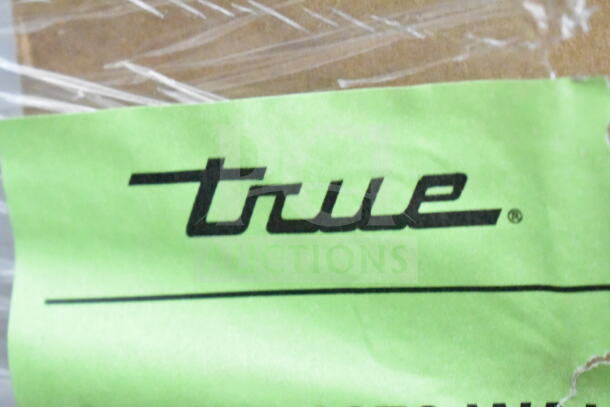 True logo on a green tag, attached to a 2026 True TSCI-600R-G-PH Commercial Cooler, brand new scratch and dent condition.