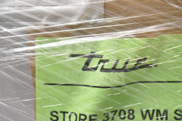 Brand new 2026 True TSCI-600R-G-PH cooler in packaging, 115V, 1 phase. True logo and store label visible through wrap.