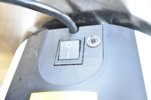 Close-up of power switch on brand new 2025 Mahlkonig E80W GBS espresso grinder, white, 120V, 1 phase, minor scratches.