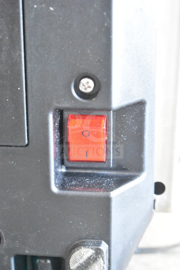 Red power switch on a black 2025 Nuova Simonelli OSCAR II AD Espresso Machine, showing minor scratches.