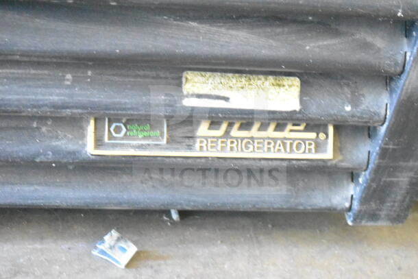 2016 True GDM-72F-HC commercial freezer badge with "natural refrigerant" label, showing minor wear.