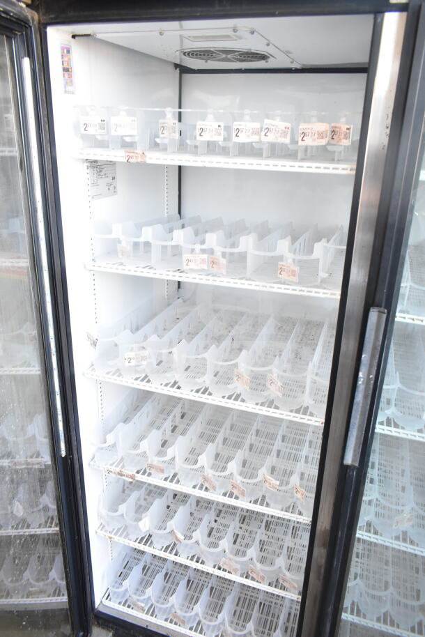 True GDM-52TM-RL-LD commercial cooler with two doors, shelves, and visible product pricing tags. 115V, gently used.