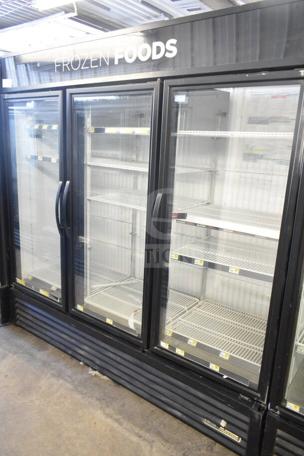 2016 True GDM-72F-HC commercial 3-door reach-in freezer, tested and working, glass doors, shelves, black exterior.