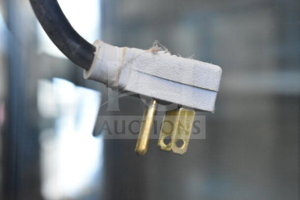 Close-up of a power plug for the 2016 True GDM-49-HC commercial cooler, 115 volts, indicating its condition.