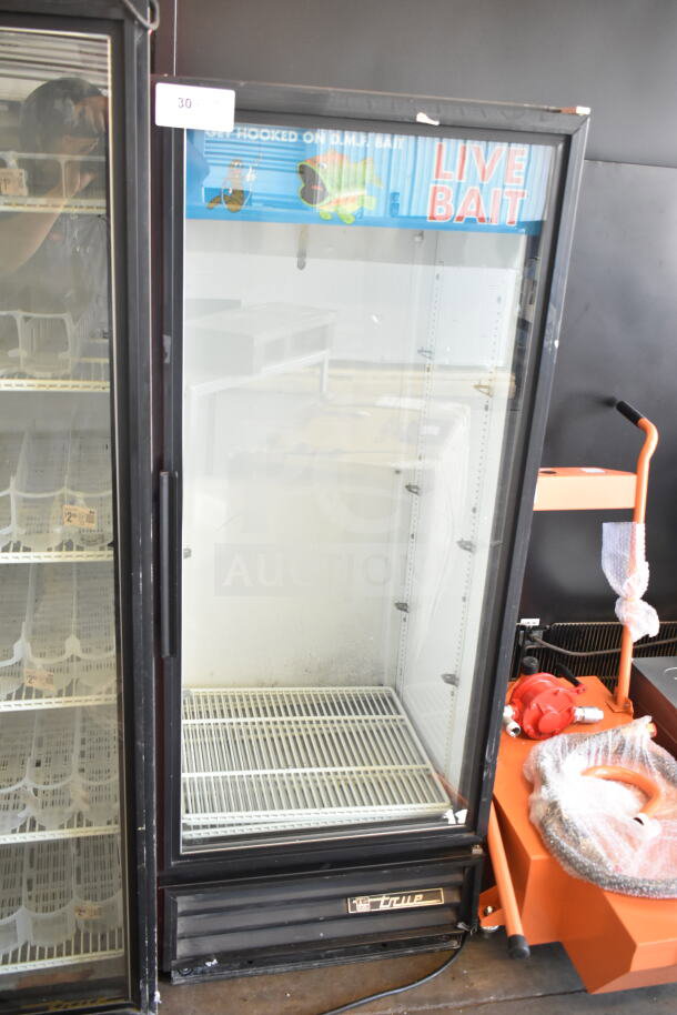 True GDM-12 commercial single door cooler merchandiser, 115 volts, 1 phase, used condition. Visible branding and glass door.
