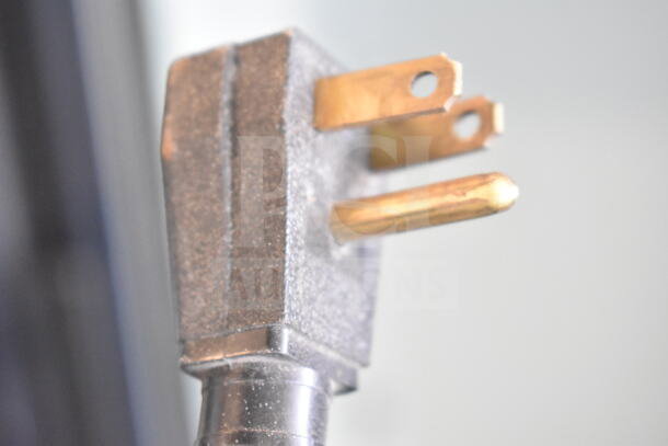 Close-up of a power plug for True GDM-12 Commercial Cooler, highlighting 115 Volts, 1 Phase compatibility.
