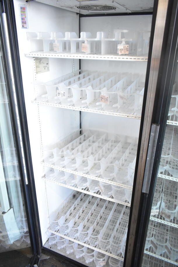 True GDM-52TM-RL-LD 2 door cooler merchandiser, tested working, 115V, shelves with product dividers, clear door handles visible.