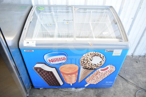 AHT RIO S 100 commercial freezer merchandiser on casters, featuring Nestlé branding. Tested and working, 115 volts, 1 phase.