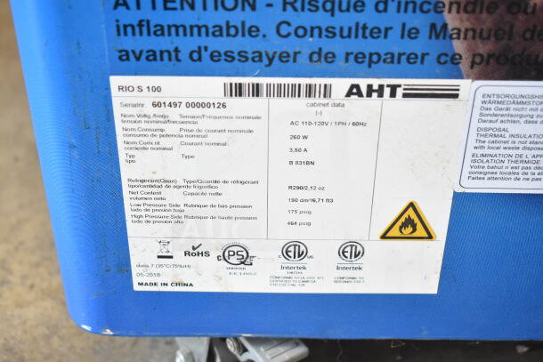 AHT RIO S 100 commercial freezer merchandiser label, showing model info, serial number, and safety certifications.