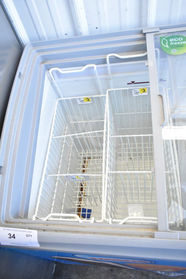 AHT RIO S 100 commercial freezer merchandiser, tested and working, on casters. Features visible pricing labels.