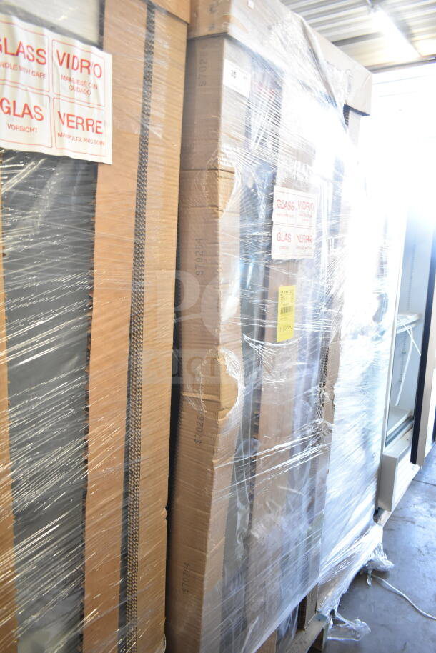 Pallet of boxed items labeled "Glass" wrapped in plastic, showing "scratch and dent" condition, with visible warning labels.
