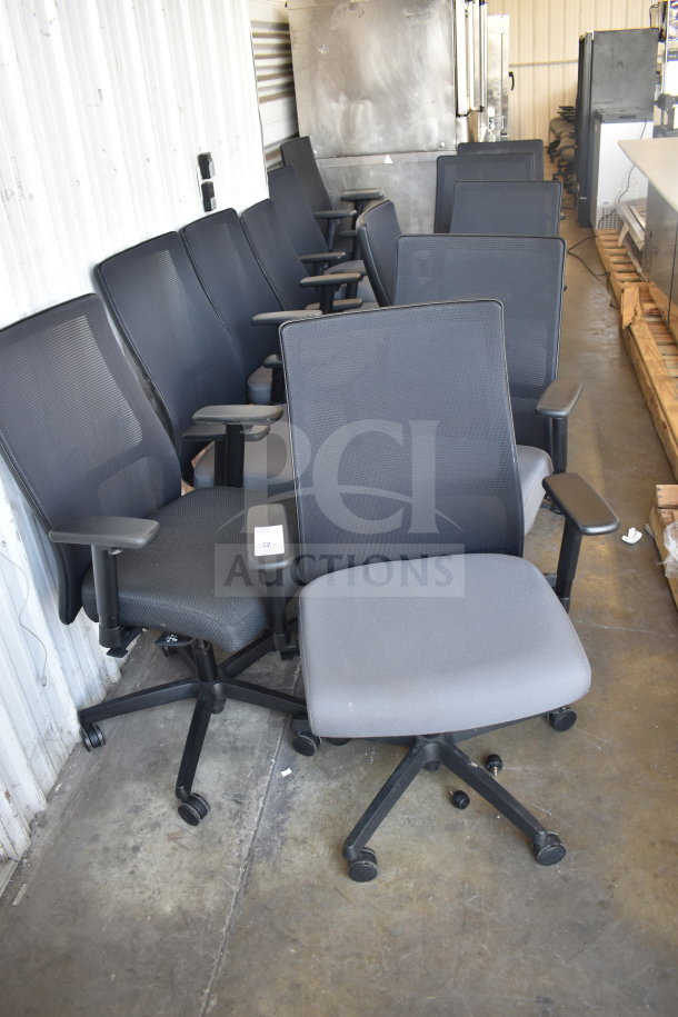 12 office chairs on casters with mesh backs and adjustable armrests in good condition.