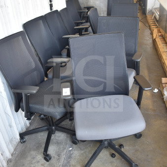 12 office chairs on casters with mesh backs and adjustable armrests in good condition.