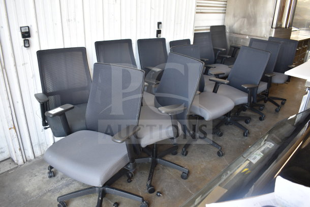 12 office chairs on casters, mesh backs, padded seats, ergonomic armrests, in good condition. Auction lot, 12 times your bid.